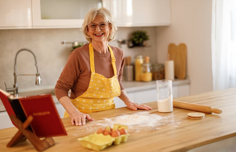Cookbook author holding her finished, professionally published book in her kitchen