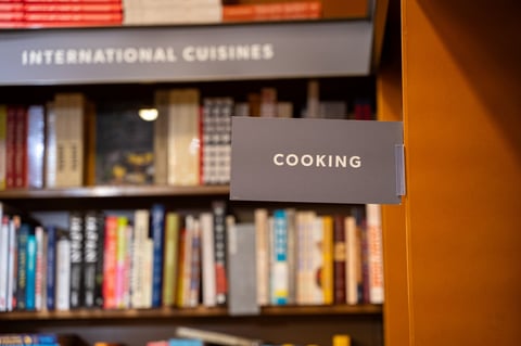 Published cookbooks on shelves in a bookstore cooking section